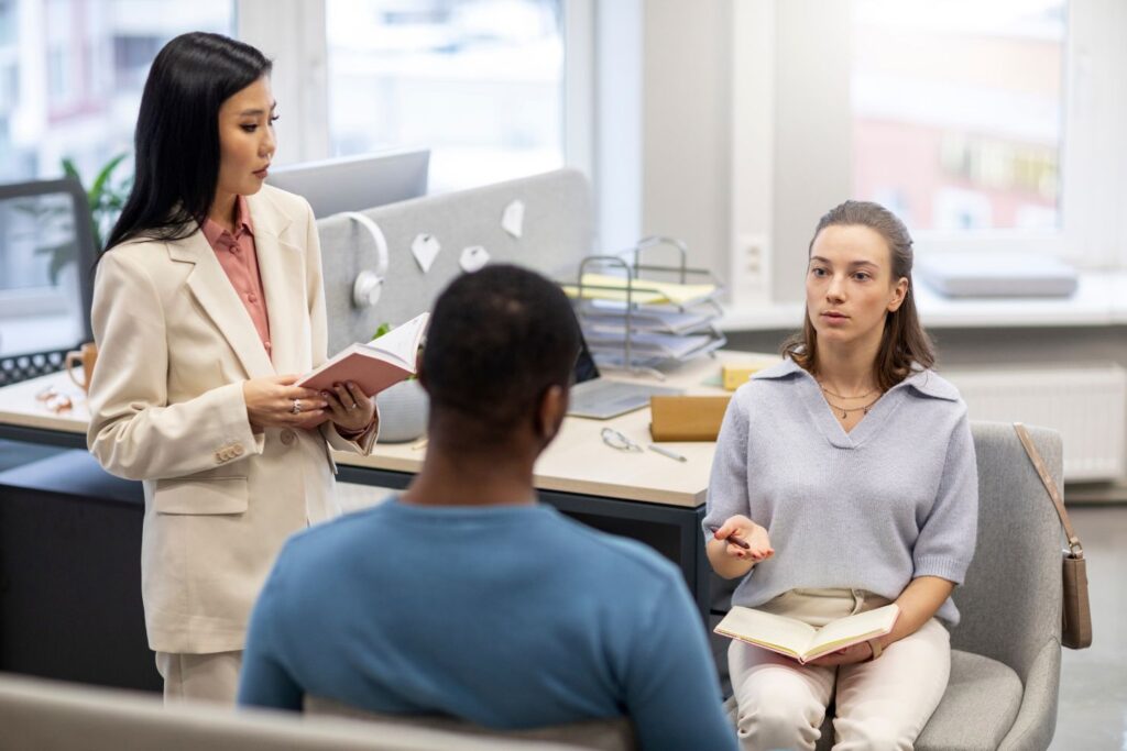 Young woman patient on individual therapy in psychologists office Mature female counselor listening taking notes talking Psychology psychiatry treatment mental health concept